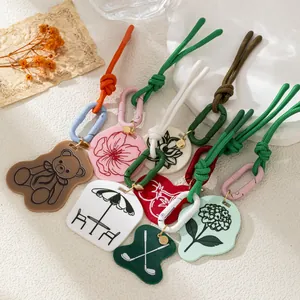 Multicolor acrylic bag charms featuring floral and teddy bear designs for a trendy casual look.