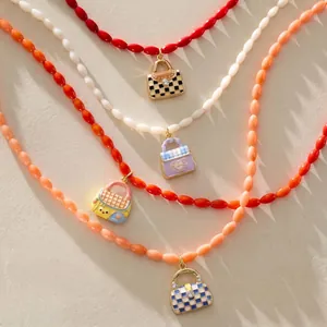 Close-up of colorful bead necklaces with mini bag enamel charms and checkered details.