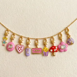 Close-up of vintage gold plated charms featuring mushroom, cassette, and flower designs