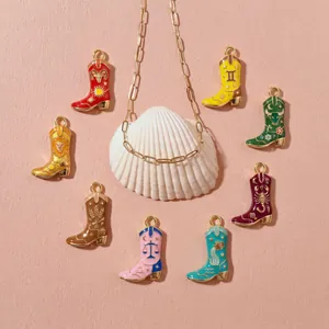 Detailed view of colorful enamel zodiac cowboy boot pendants on a shell background