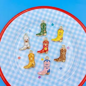 Detailed view of colorful zodiac enamel cowboy boot pendants with gold trim for DIY jewelry.