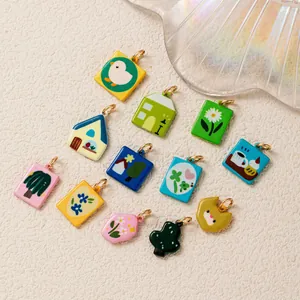 Detailed view of colorful 18K gold plated charms with cute house and animal designs