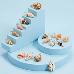 Detailed view of hand-painted nautical seashell pendants on blue geometric displays.