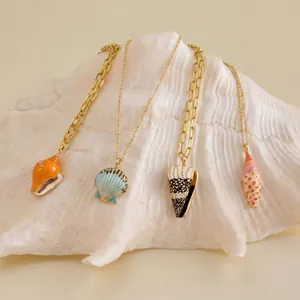 Detailed view of hand-painted colorful shell necklaces on a natural large sea shell prop.