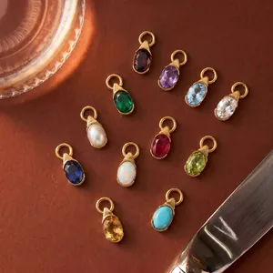 Collection de douze pendentifs pierres de naissance en forme de goutte et bordure dorée