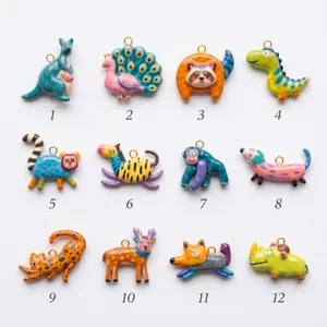 Collection of twelve colorful hand-painted dopamine style animal pendants for DIY jewelry