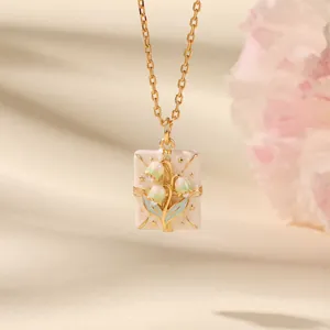 Close-up of French style cream envelope pendant with Lily of the Valley flowers.