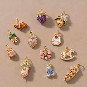 Macro view of various colorful enamel charms including fruit, animals and cute objects