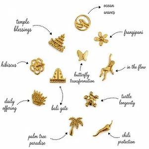 Collection of gold locket charms with hibiscus, butterfly, and palm tree designs.