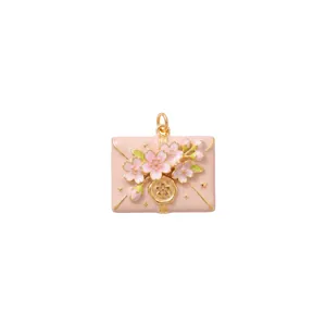 Detailed view of pink envelope pendant with 3D cherry blossom flowers.