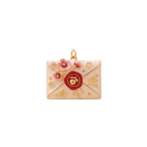 Detail view of a French style envelope pendant with pink flowers and a red wax seal detail