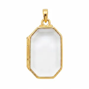 Detailed macro shot of an octagonal gold-plated locket pendant with clear glass front.