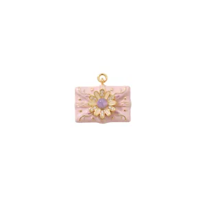 Detailed close-up of a pink enamel envelope pendant with a sparkling crystal flower ornament.