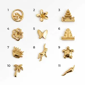 Selection of gold-plated charms including flower, butterfly, palm tree, and turtle shapes.