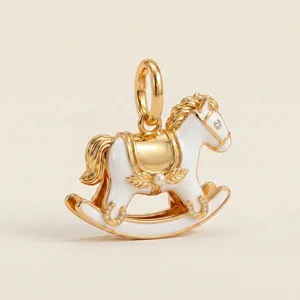 Detailed view of a 14K gold-plated enamel rocking horse pendant with rhinestones.