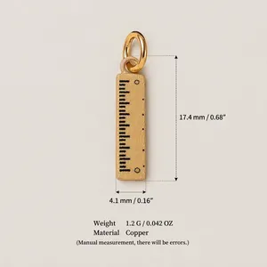 Petit pendentif règle en cuivre doré avec mesures et spécifications détaillées