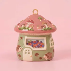 Whimsical ceramic mushroom house pendant featuring cute hedgehog and berry patterns.