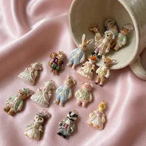 Detailed view of assorted cute cartoon animal charms in Victorian outfits for DIY