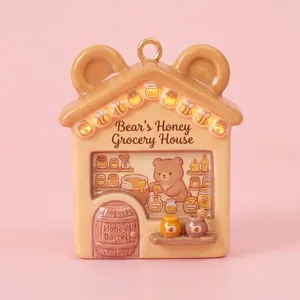 Detailed view of fairy tale house pendant featuring a cute bear honey shop design