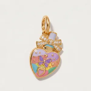 Detailed view of a colorful enamel heart pendant with a crystal-set bow and butterfly motif.