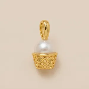 Detailed view of elegant golden ice cream cone charm with a large white pearl