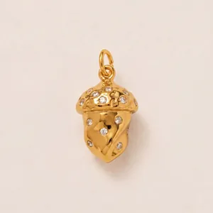 Vue macro d'un pendentif gland doré avec pierres scintillantes pour bijoux DIY.