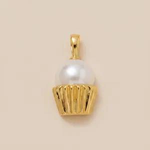Detailed macro view showing an elegant ice cream shaped pearl pendant with a golden base.