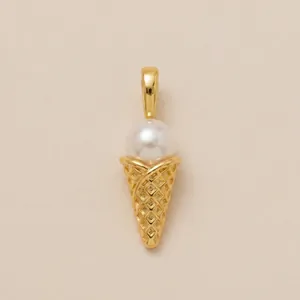 Close-up detail of a gold ice cream cone charm with a lustrous white pearl scoop.
