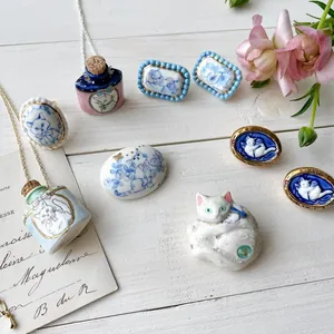Hand-painted ceramic cat jewelry collection featuring wish bottle necklaces and feline rings.
