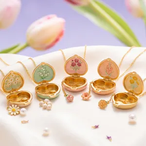 Detailed macro view of open colorful enamel heart necklaces featuring diverse floral designs
