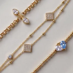 Detailed macro view of various titanium steel gold plated bracelets with cubic zirconia.