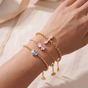 Macro view of three gold-plated titanium steel bracelets with colorful zirconia stones