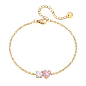 Detailed view of gold plated titanium steel bracelet with pink and white heart zircons