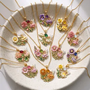 Detail of enamel flower fairy necklaces with colorful gemstones in a ceramic plate.