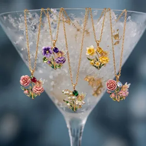 Macro view of five colorful fairy and flower enamel necklaces featuring various gemstones
