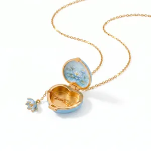 Detail showing heart-shaped blue enamel locket with intricate painted lily art