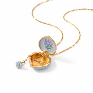 Detailed macro view of an open heart-shaped enamel locket necklace with purple flowers.