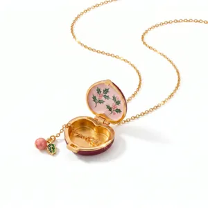 Detailed interior view of a heart-shaped enamel locket necklace with pink floral patterns