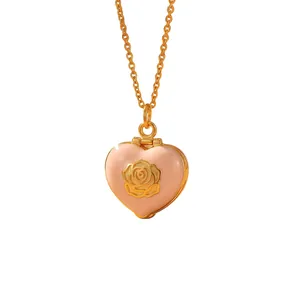 Detailed view of a pink enamel heart locket necklace with a golden rose pattern design