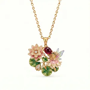 Detail of an intricate enamel fairy and lotus pendant with a red gemstone.