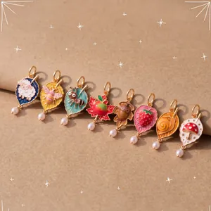 Set of colorful enamel leaf charms featuring cute animal and fruit motifs with pearl accents