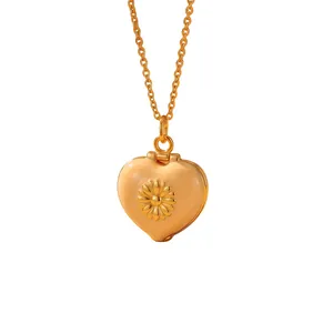 Close-up of golden enamel heart locket necklace with delicate daisy flower design