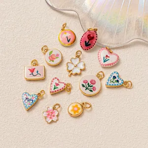 Colorful enamel dopamine pendants featuring floral heart and clover motifs for jewelry