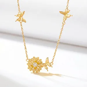 Detailed view of elegant gold-tone flower necklace with butterflies and crystal center.