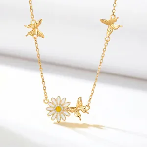 Detailed view of the gold-plated necklace featuring a daisy pendant and butterflies