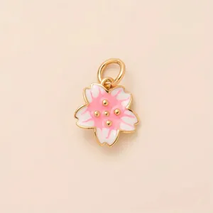 Gold-plated cherry blossom pendant with pink and white enamel detail for jewelry making