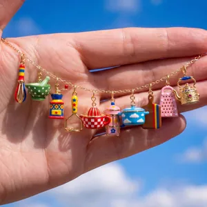 Detailed view of colorful miniature enamel kitchenware charms on a gold-plated chain necklace