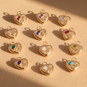 Detail view of heart-shaped zodiac pendants with colorful gemstones and gold finish.