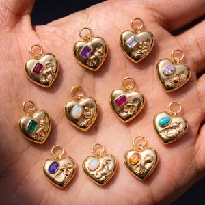 Detailed view of 316L stainless steel heart pendants with embossed zodiac signs and gems