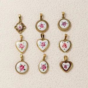 Detailed view of nine 18K gold plated vintage style heart and round floral painted pendants